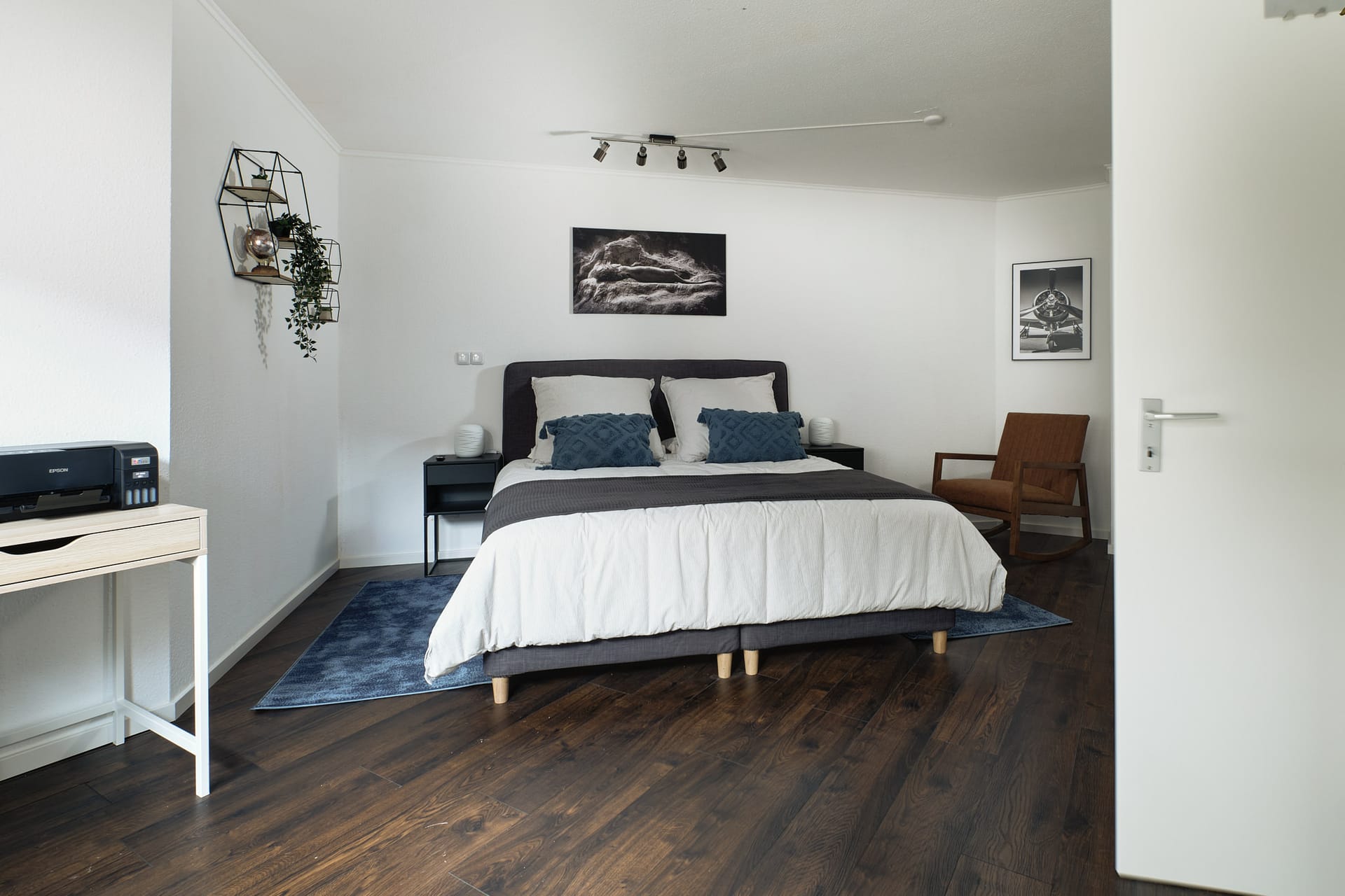 Master bedroom with king bed and teal accents in Landstuhl TLA